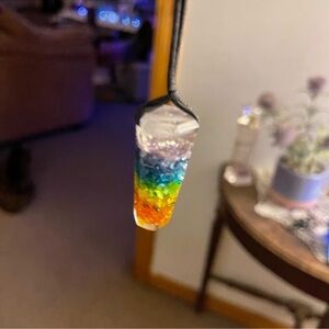 Pendant filled with multi crystals    Comes with long adjustable rope